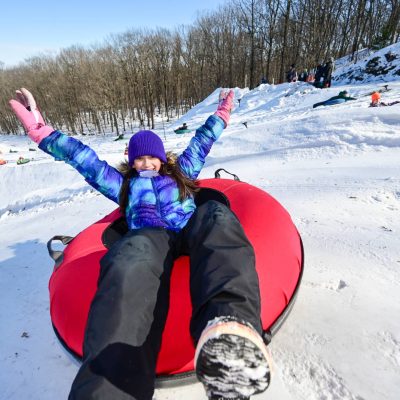 Related Article: Get out and play: Your guide to active winter fun in Wisconsin | girl in inner tube at Powers Bluff County Park in Arpin Wisconsin