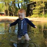 Article: Wisconsin beaches that are fun for the whole family | child swimming at beach boulder junction wi