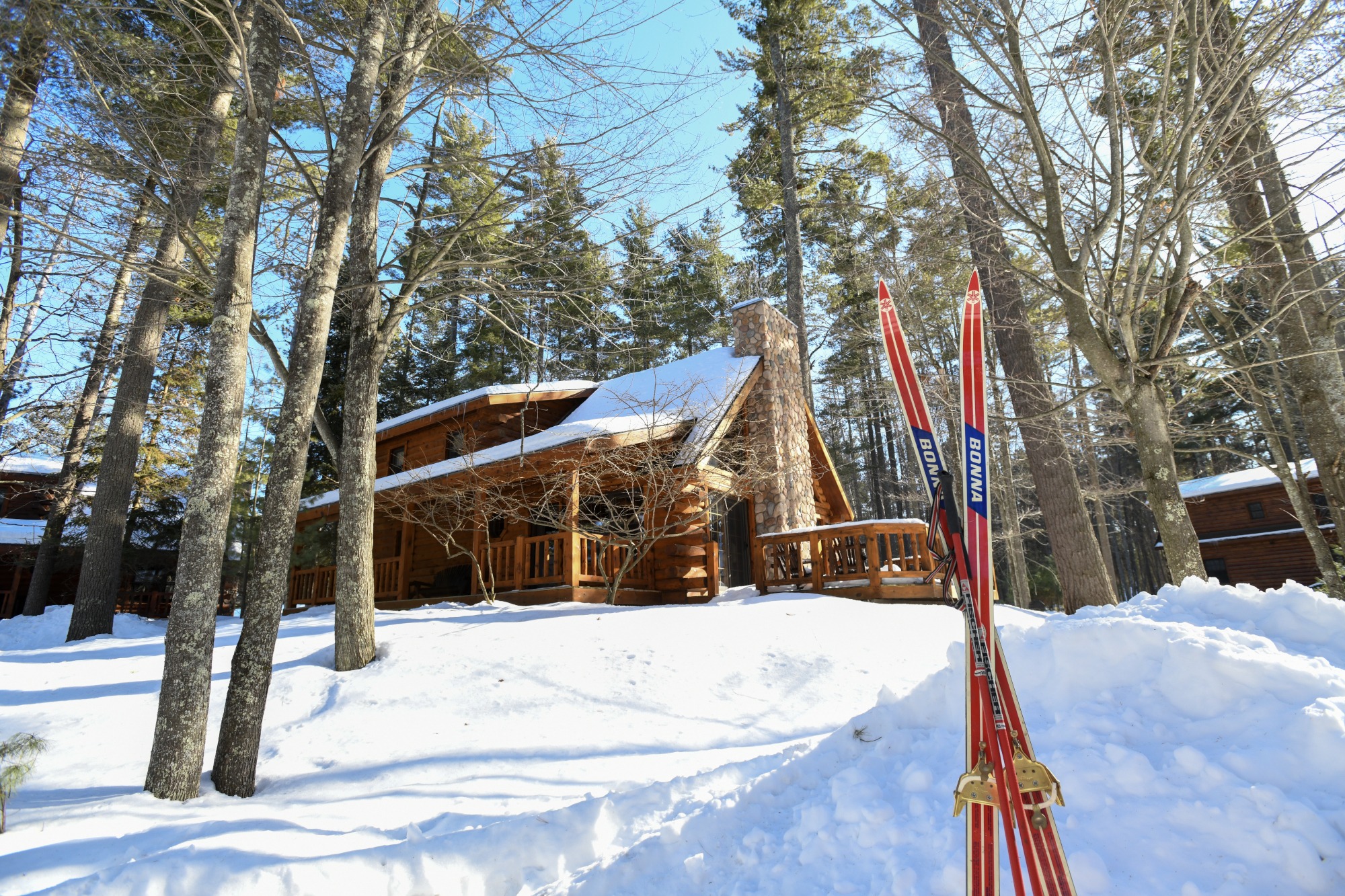 cross-country skis in the snow outside a cabin at the beacons of minocqua in oneida county in northern wisconsin