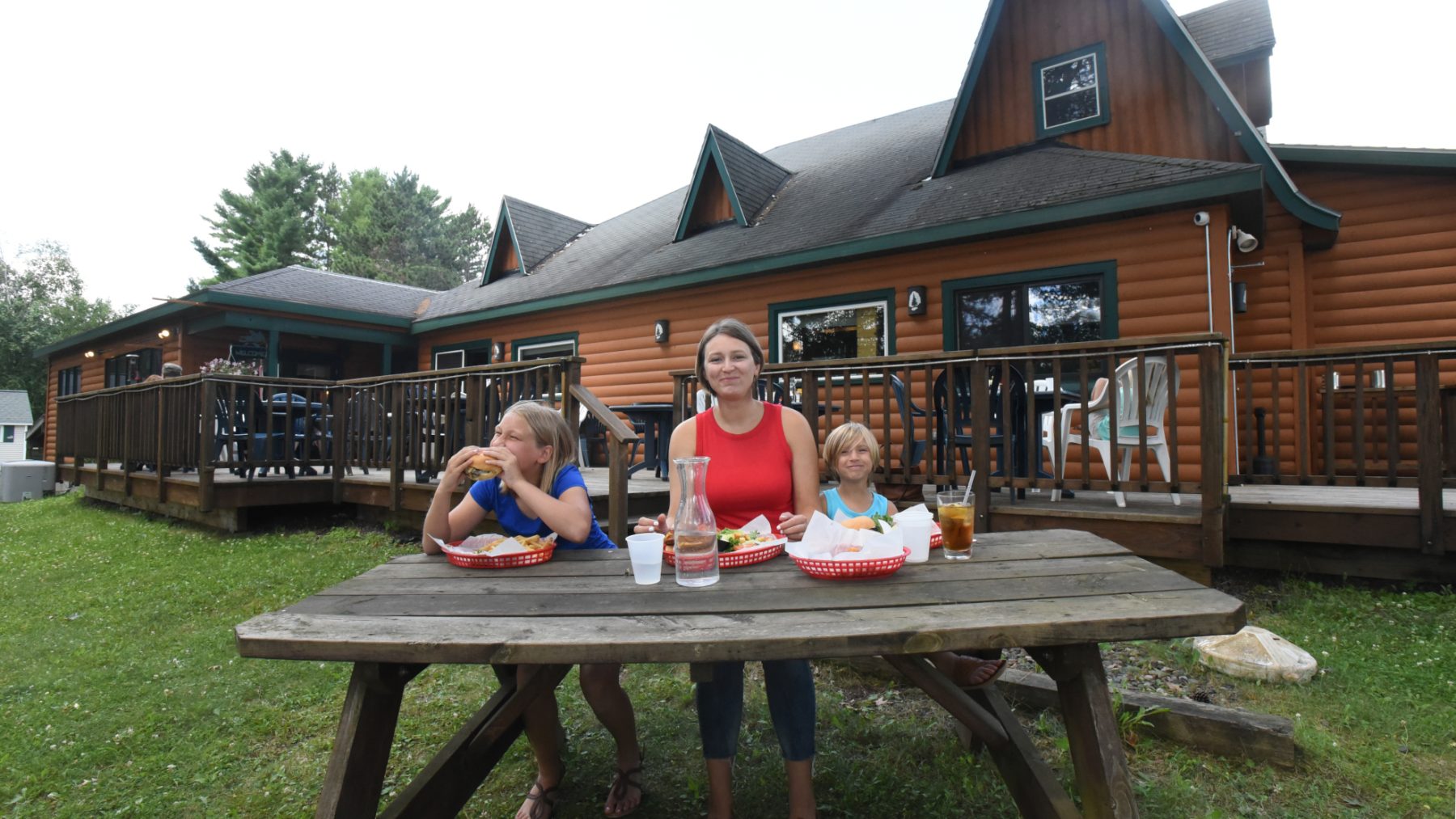Article: Amazing spots for outdoor dining & drinks in Wisconsin | Family eating outdoors at Headwaters Restaurant Boulder Junction WI