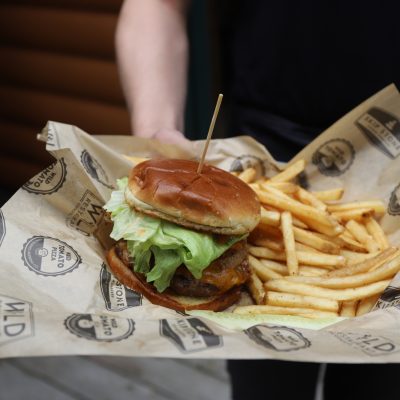 Related Article: Where to find Wisconsin’s best burgers | server carrying burger and fries at restaurant in boulder junction wisconsin