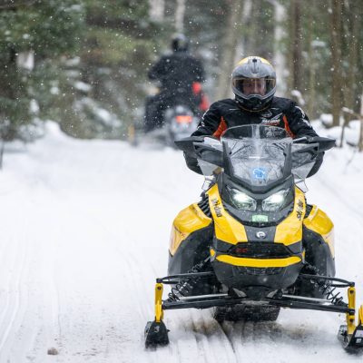Related Article: Your guide to snowmobiling Wisconsin’s Northwoods | Man on snowmobile on trail in Phelps in Vilas County Wisconsin
