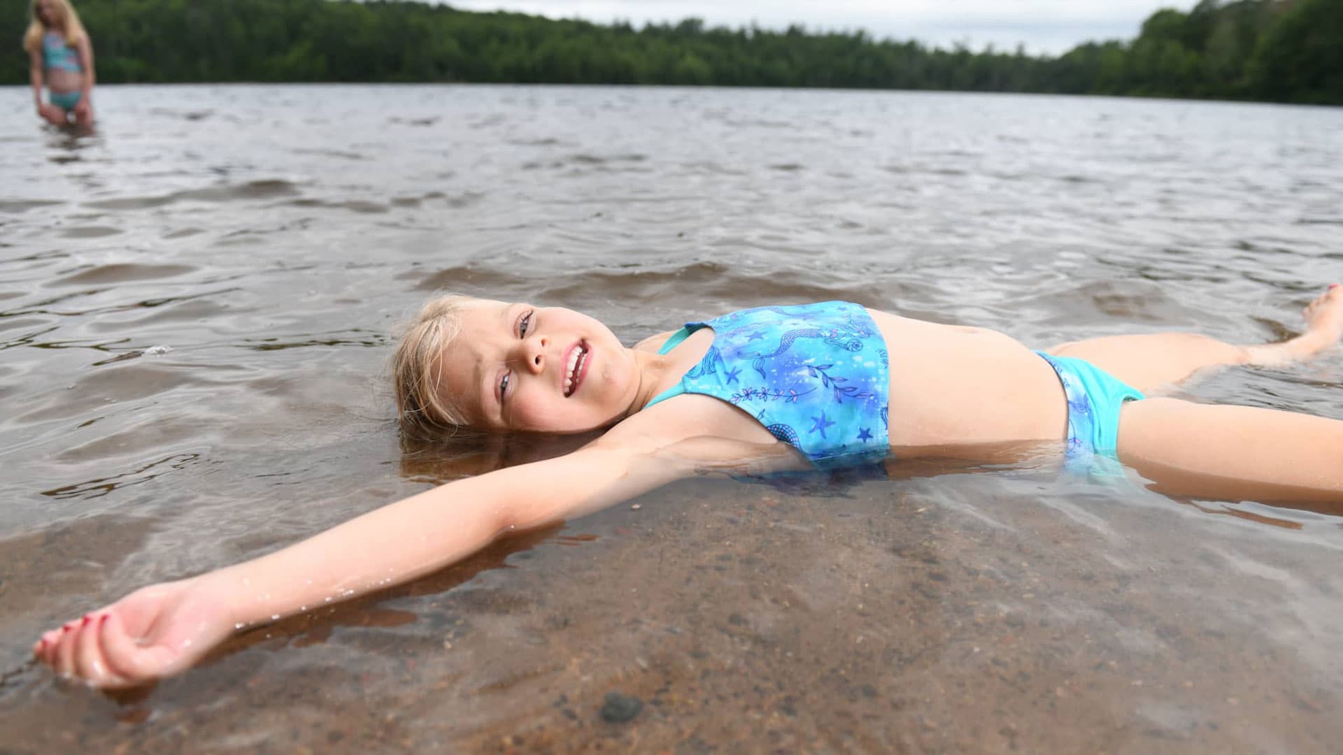 Girl swimming at Nichols Beach in Boulder Junction WI