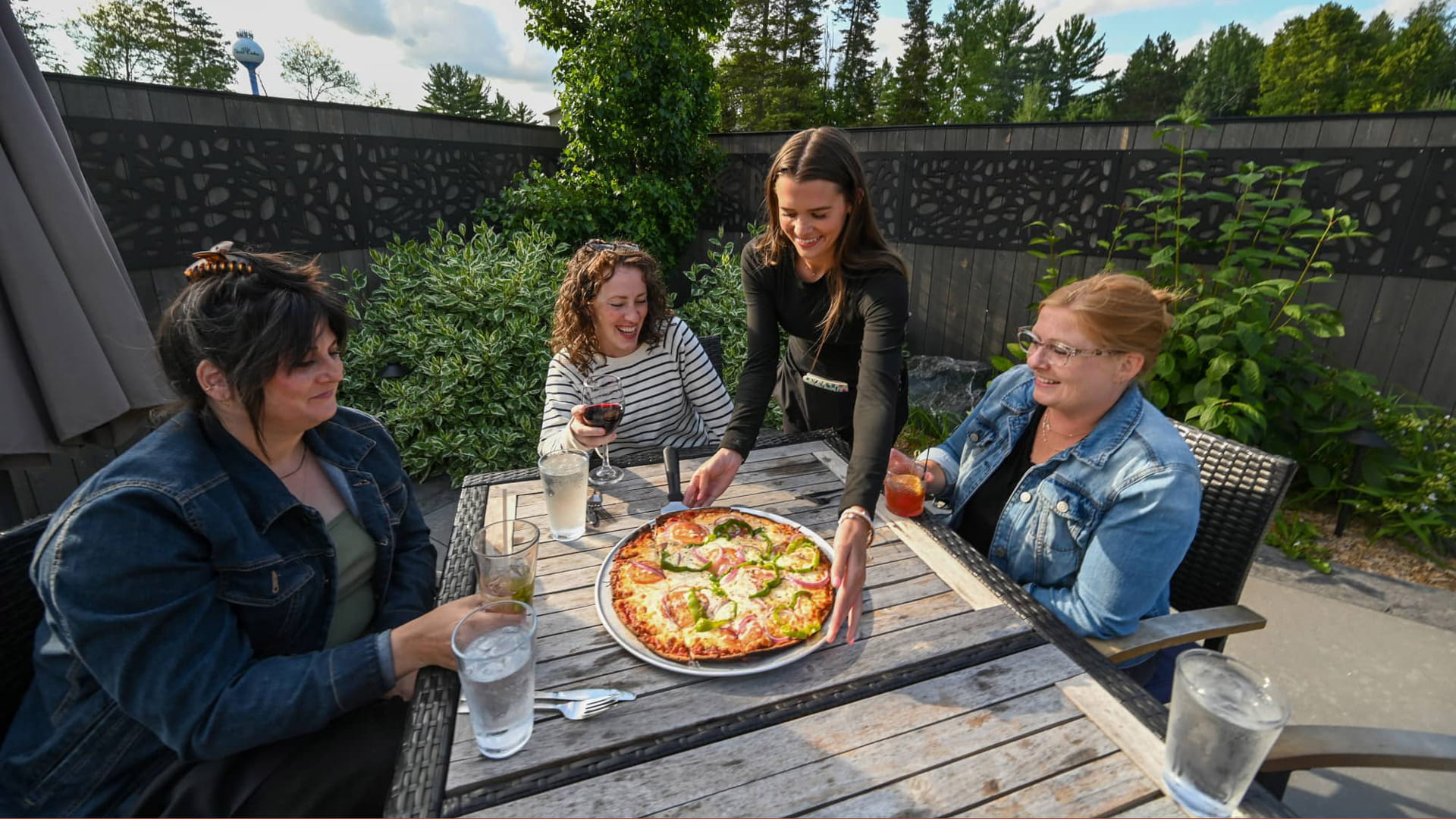 Women eating pizza at Claytons’ 1881 Room Three Lakes Oneida County WI