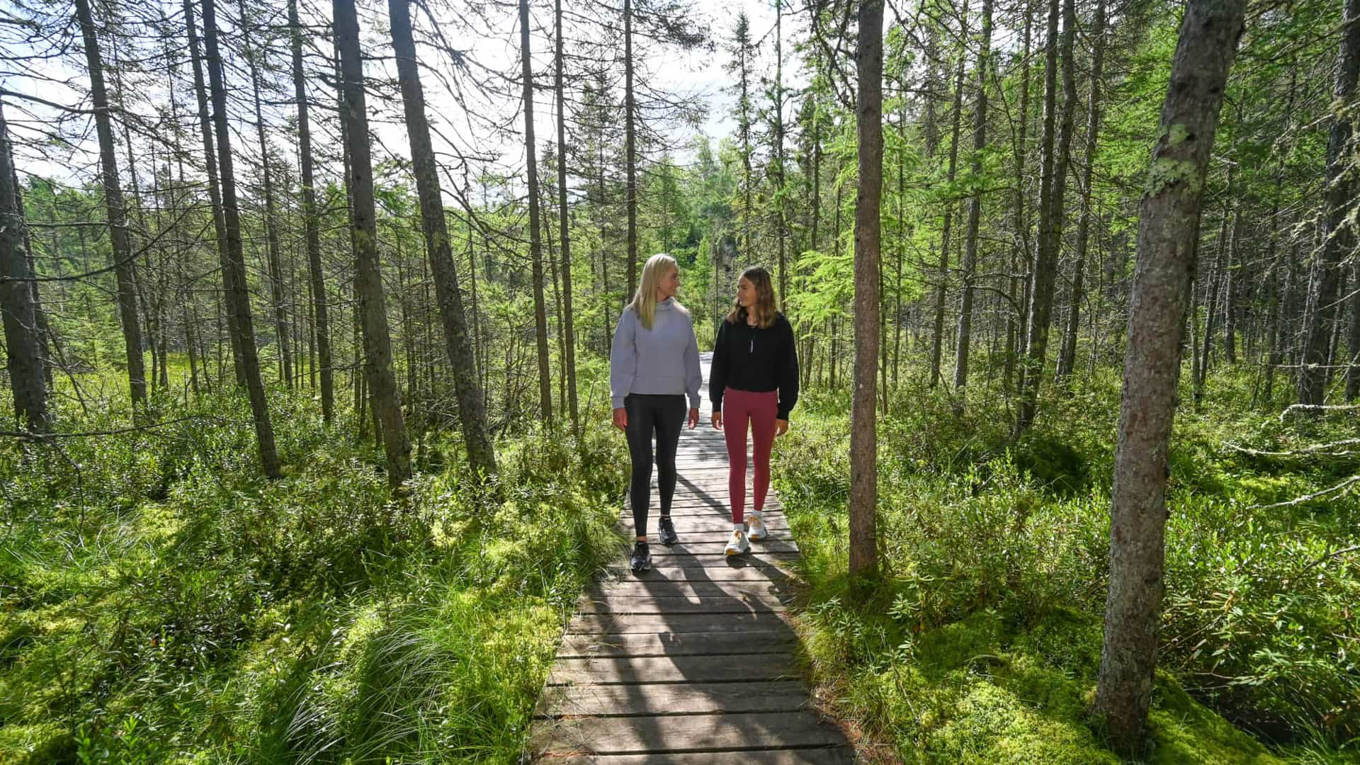 Mother and daughter walking on Raven Trail near Minocqua, Wisconsin