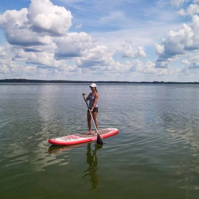 Related Article: Where to go canoeing & kayaking in Oneida County | Woman stand-up paddleboarding on Pelican Lake in Oneida County Wisconsin