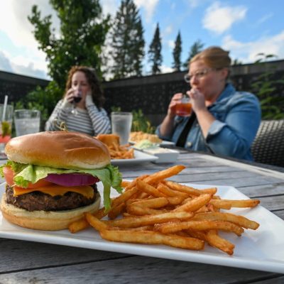 Related Article: Where to find great burgers in Oneida County | Cheeseburger on table in front of three women at Claytons 1881 Room restaurant in Three Lakes Wisconsin