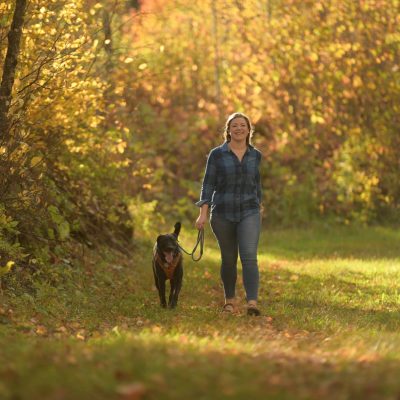 Related Article: One hiking trail to try in each Vilas County community | woman walking her dog on the Shannon Trail in Vilas County Wisconsin in fall