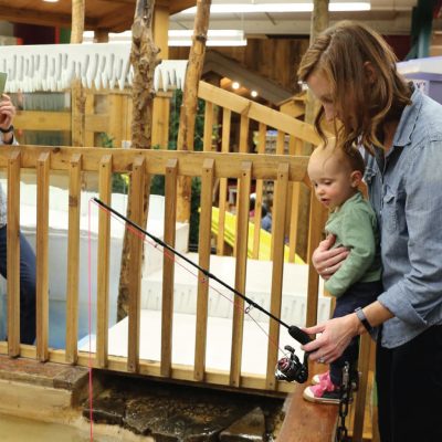 Related Article: 5 children’s museums to visit in Wisconsin | Woman taking photo of mother and child at fishing pond at Northwoods Children’s Museum in Eagle River in Vilas County Wisconsin