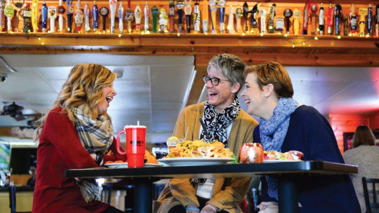Article: Where to find a fish fry in Marshfield | Three women sitting at a table laughing at Nutz Deep II restaurant in downtown Marshfield Wisconsin