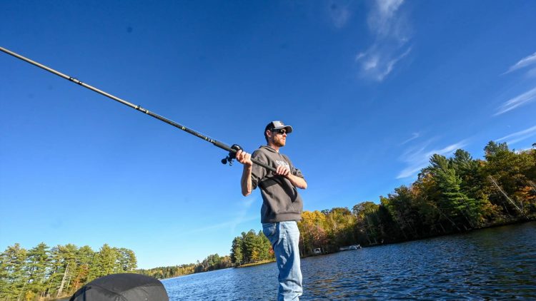 Article: Where to find musky, walleye & more in Oneida County | Man casting a musky pole from a boat on a lake in Oneida County Wisconsin